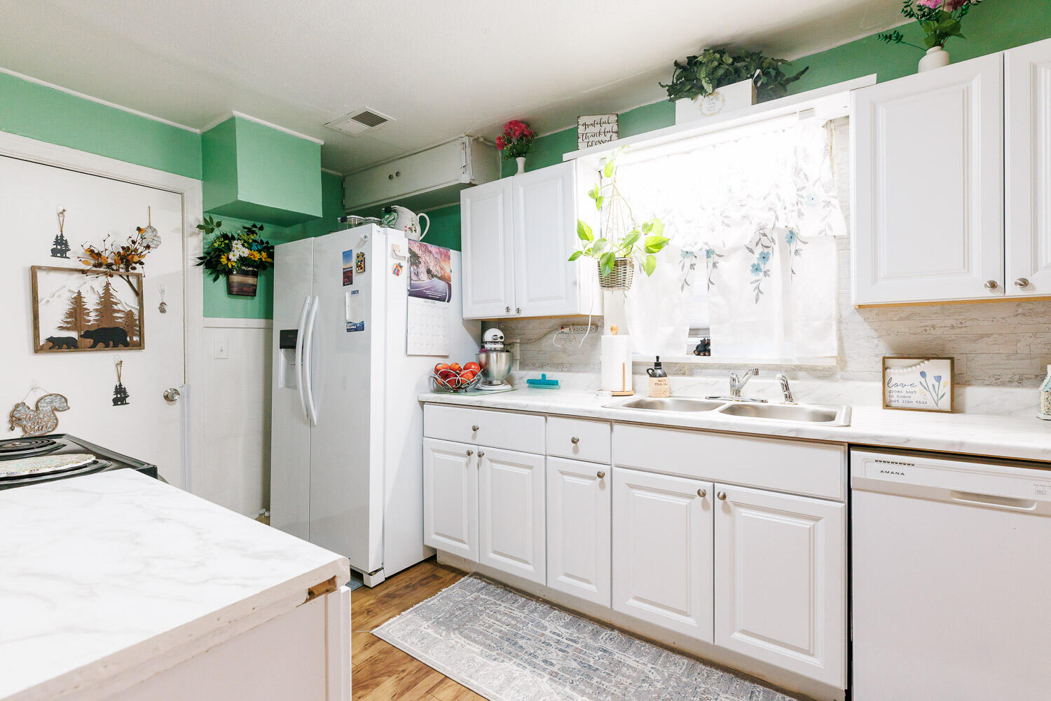 2004 26th Street Lubbock, TX 79411 - Photo 9 of 16 a kitchen with white cabinets and refrigerator