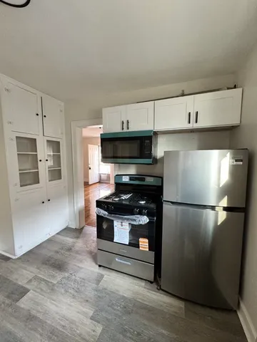 a kitchen with a refrigerator and a stove top oven