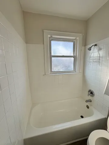 a bathroom with a bathtub and a shower