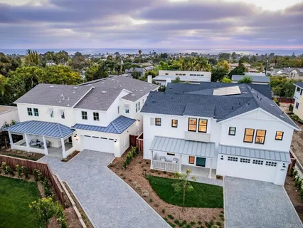 an aerial view of residential houses with outdoor space and street view