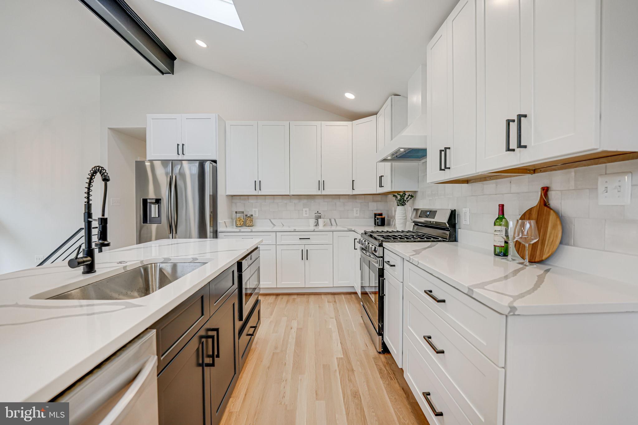 5108 Sutton Place Alexandria, VA 22304 - Photo 14 of 53 a kitchen with stainless steel appliances granite countertop a sink stove and refrigerator