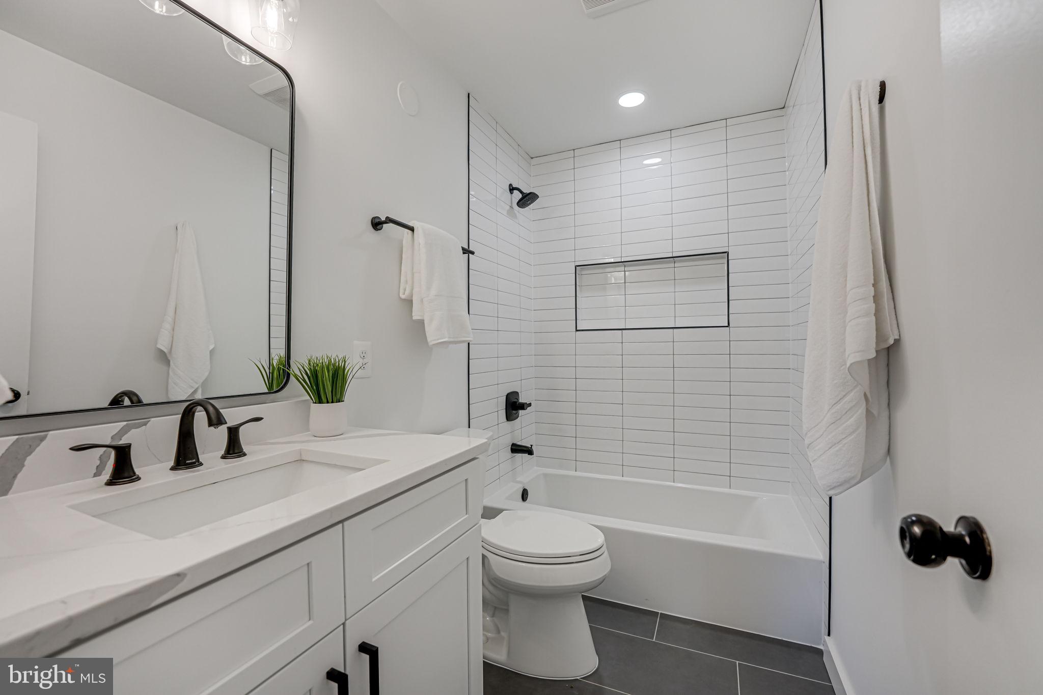 5108 Sutton Place Alexandria, VA 22304 - Photo 30 of 53 a bathroom with a sink a toilet and shower