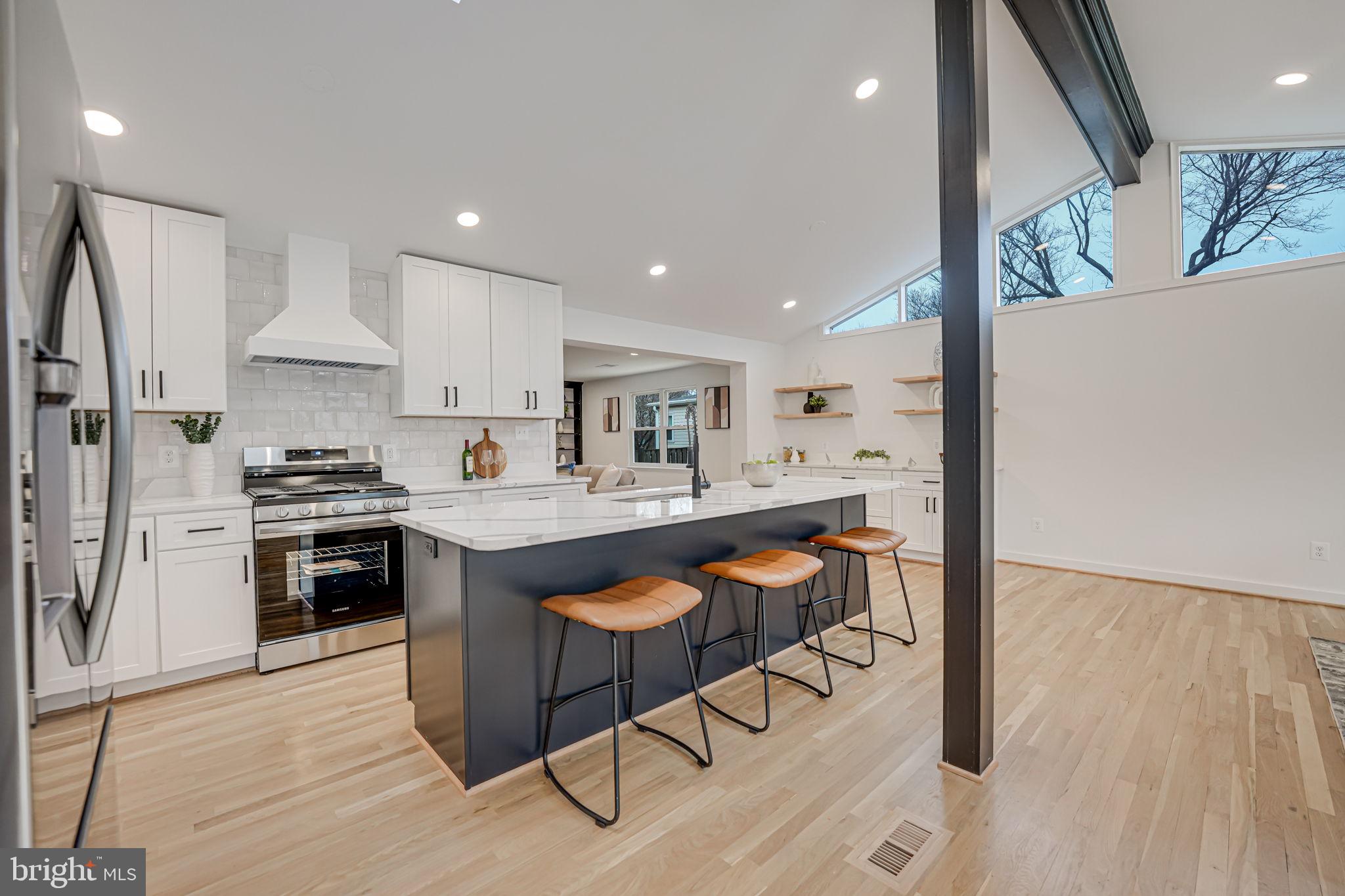 5108 Sutton Place Alexandria, VA 22304 - Photo 10 of 53 a kitchen with stainless steel appliances granite countertop a stove top oven a sink dishwasher and a refrigerator with wooden floor