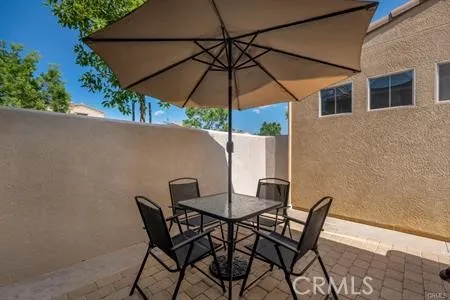 a patio table and chairs under an umbrella