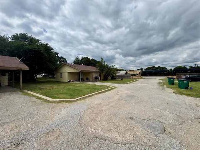 a view of a house with a yard and sitting area