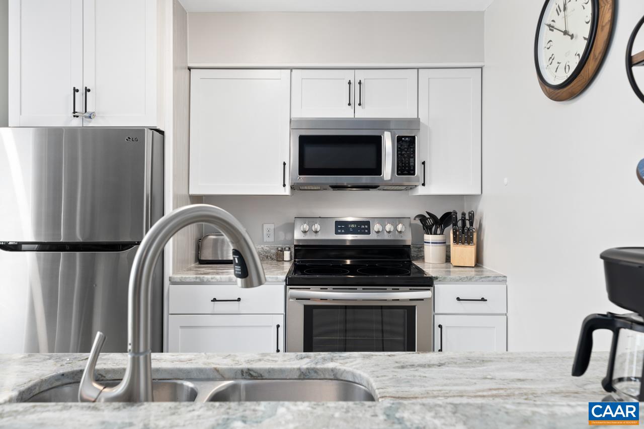 2240 Tanners Ridge Roseland, VA 22967 - Photo 11 of 30 a kitchen with stainless steel appliances granite countertop a stove top oven a refrigerator and a microwave