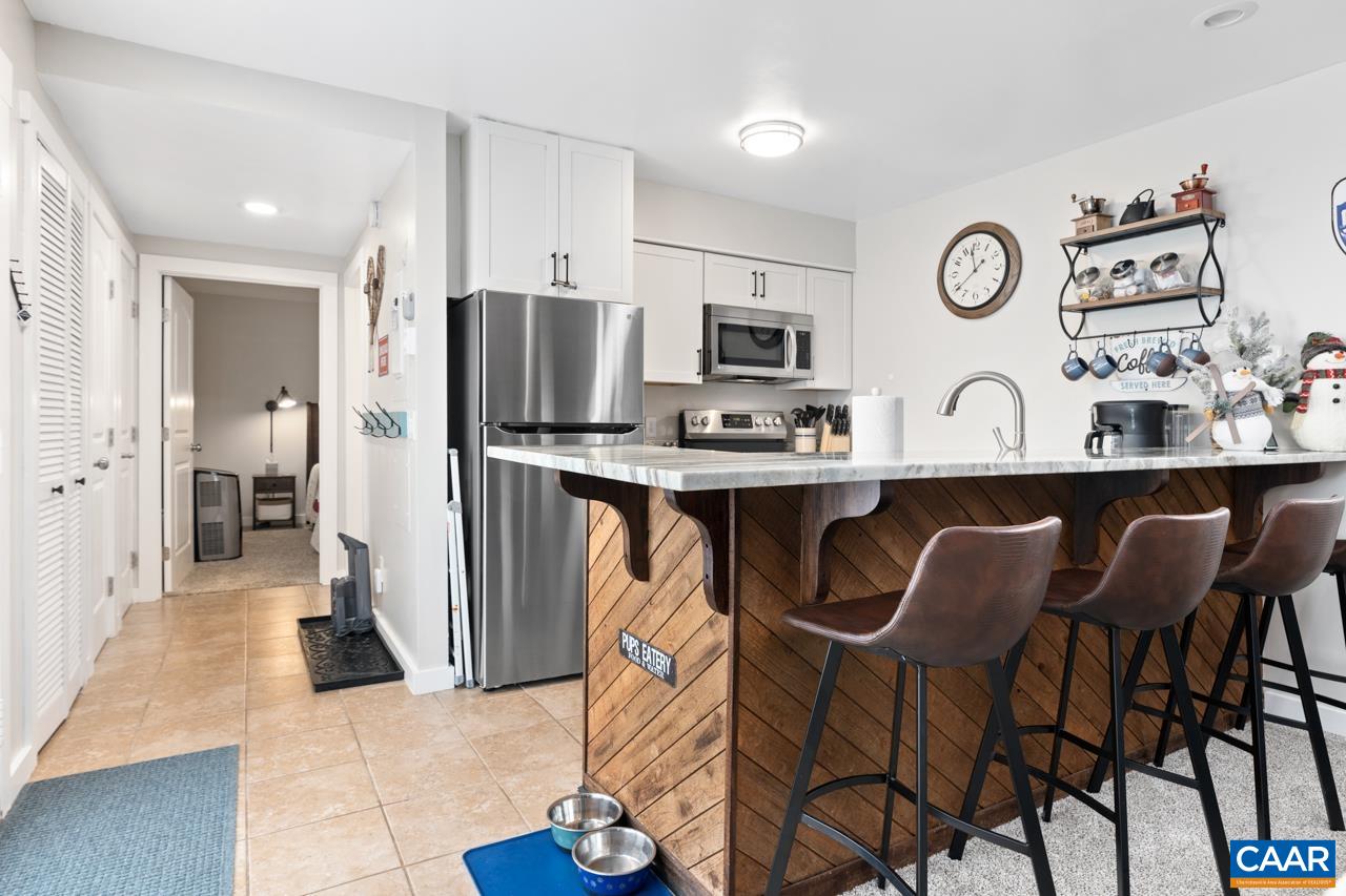 2240 Tanners Ridge Roseland, VA 22967 - Photo 7 of 30 a kitchen with stainless steel appliances granite countertop a table chairs refrigerator and sink