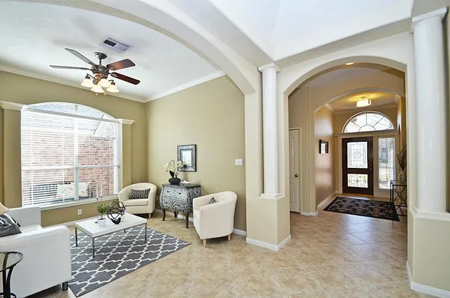 a living room with furniture and a large window