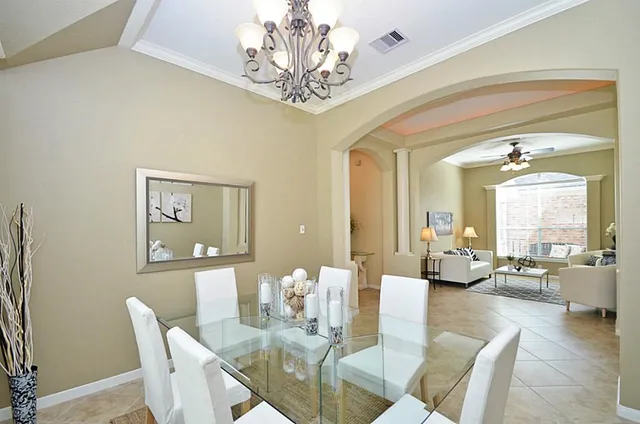 a view of a dining room with furniture wooden floor and chandelier