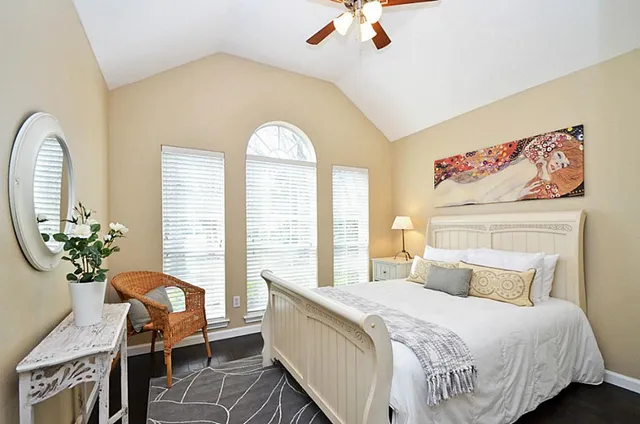 a bedroom with a bed and a chandelier