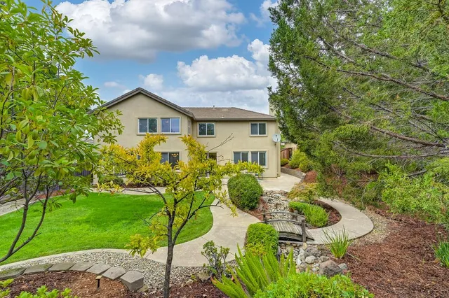 a view of a house with a yard and garden