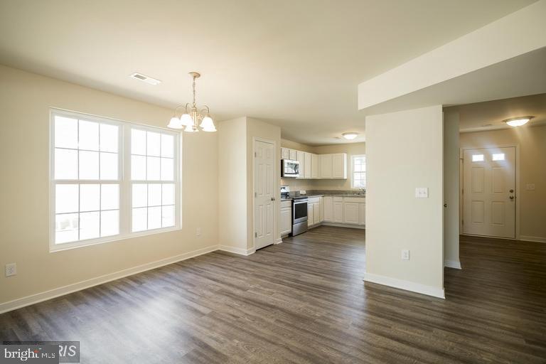208 Bend Farm Road Fredericksburg, VA 22408 - Photo 4 of 16 an empty room with wooden floor and windows