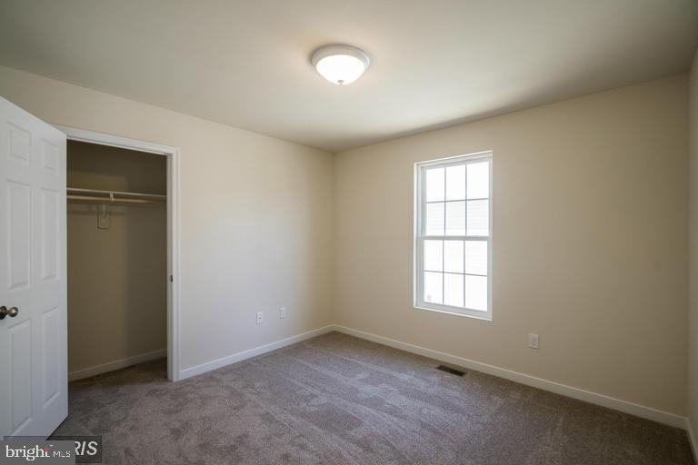 208 Bend Farm Road Fredericksburg, VA 22408 - Photo 8 of 16 an empty room with windows and closet