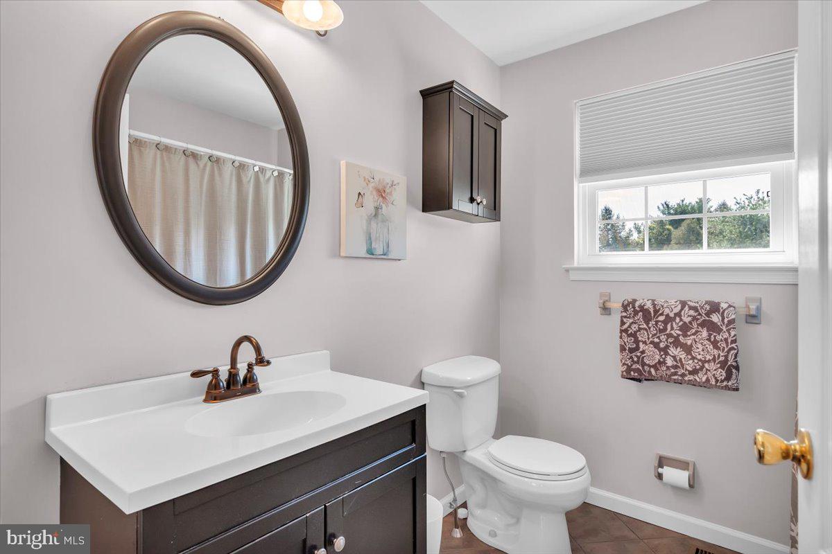 6 Rainbow Drive Sewell, NJ 08080 - Photo 20 of 29 a bathroom with a toilet a sink and a mirror