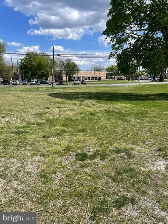 a view of a big yard with table and chairs