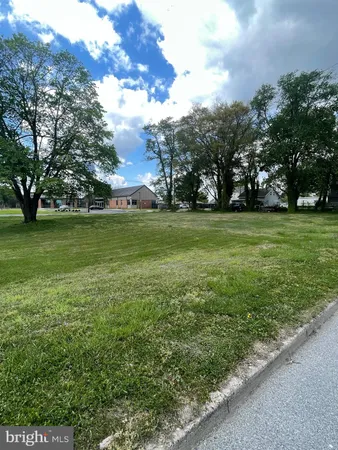 a view of a fountain in front of a building with a big yard