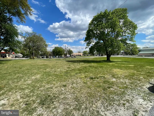 a view of a fountain in front of a building with a big yard
