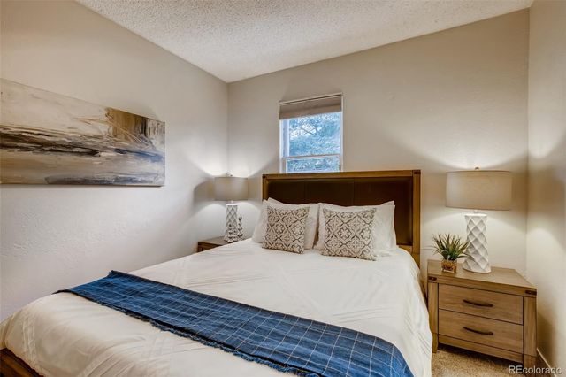 a bedroom with a bed and a night stand