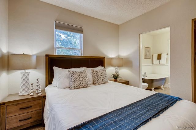 a bedroom with a bed and a night stand