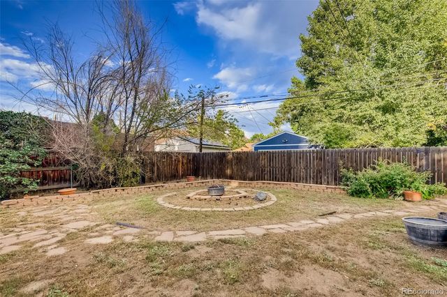 a backyard of house with trees and outdoor seating