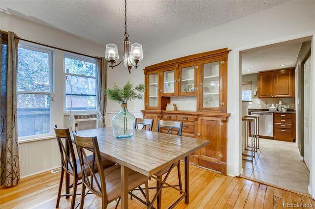 a view of a dining room with furniture large window and wooden floor