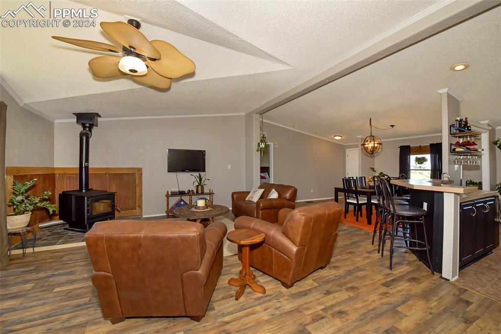 3975 Feather Ridge Drive Peyton, CO 80831 - Photo 18 of 36 a living room with fireplace furniture and a flat screen tv