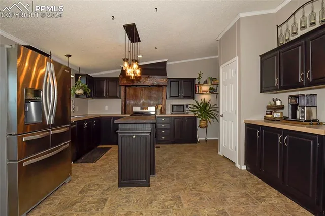 a kitchen with refrigerator and window