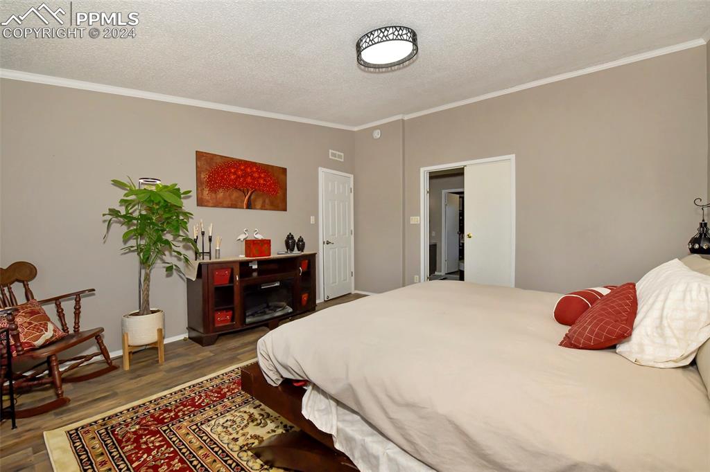 3975 Feather Ridge Drive Peyton, CO 80831 - Photo 27 of 36 a bedroom with a bed and dresser with chair