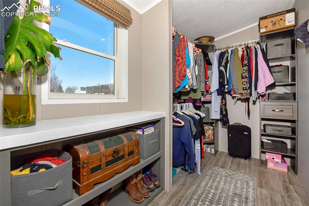 3975 Feather Ridge Drive Peyton, CO 80831 - Photo 30 of 36 a view of walk in closet with clothes and shoes