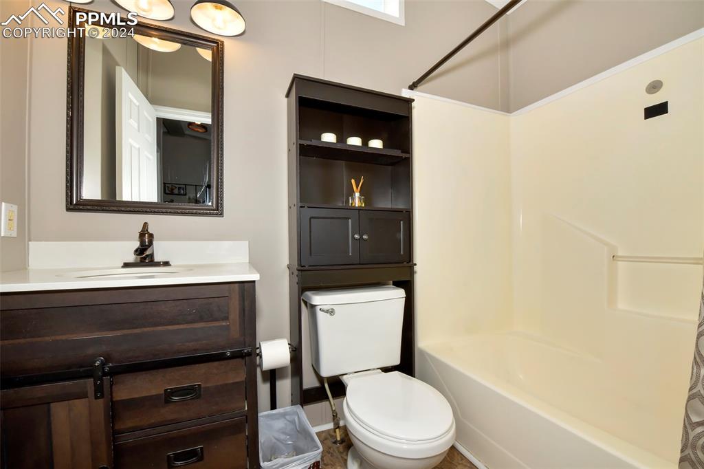 3975 Feather Ridge Drive Peyton, CO 80831 - Photo 31 of 36 a bathroom with a sink a toilet and shower