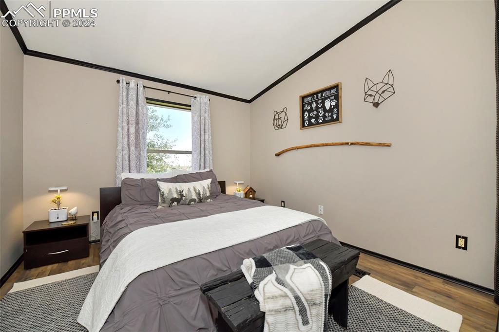 3975 Feather Ridge Drive Peyton, CO 80831 - Photo 32 of 36 a bedroom with a bed and a window