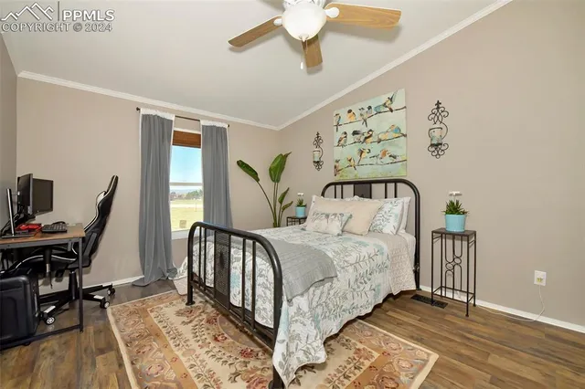 a bedroom with a bed and a ceiling fan
