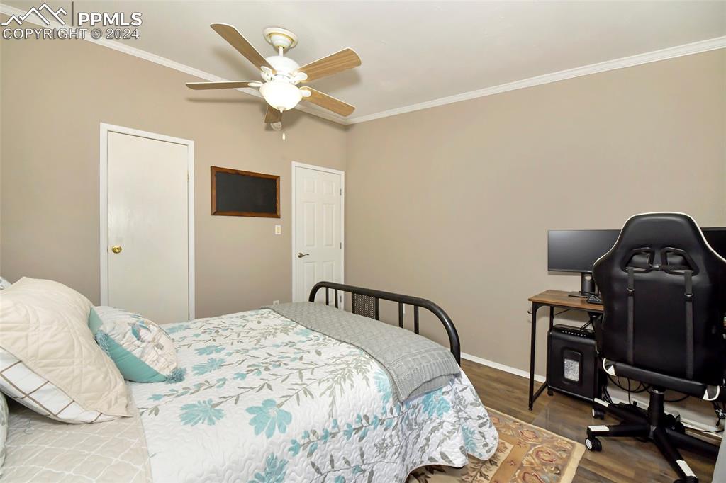 3975 Feather Ridge Drive Peyton, CO 80831 - Photo 35 of 36 a bedroom with a bed and a ceiling fan