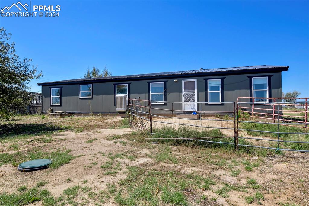 3975 Feather Ridge Drive Peyton, CO 80831 - Photo 9 of 36 a front view of a house with garden