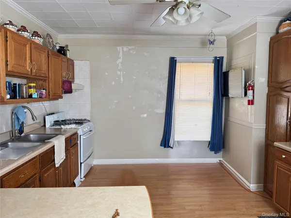 a kitchen with stainless steel appliances granite countertop a refrigerator a sink a stove and island