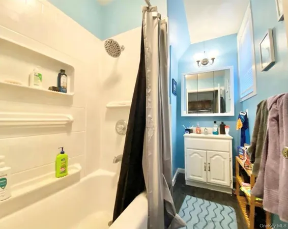 a bathroom with a sink a mirror and a bathtub