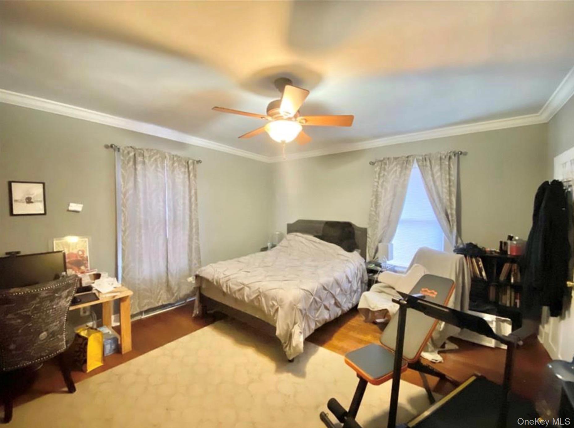 97 Deblock Road New Hampton, NY 10958 - Photo 21 of 31 a bedroom with a bed and a chandelier