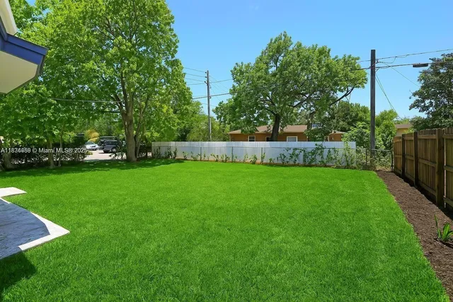 a view of yard with swimming pool and green space