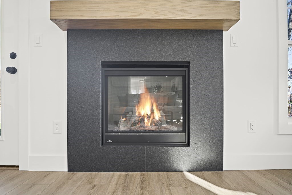 25 Salisbury Hill Boulevard, Unit 65 Worcester, MA 01609 - Photo 14 of 42 a view of a livingroom with wooden floor and a fireplace