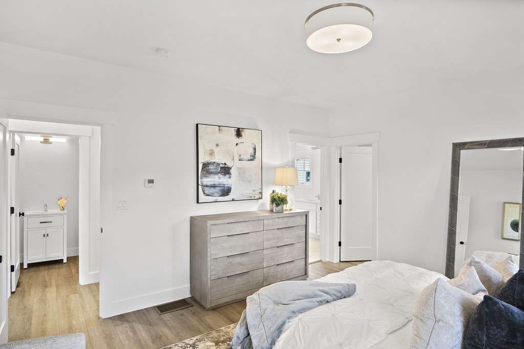 25 Salisbury Hill Boulevard, Unit 65 Worcester, MA 01609 - Photo 17 of 42 a bedroom with a bed and a chandelier