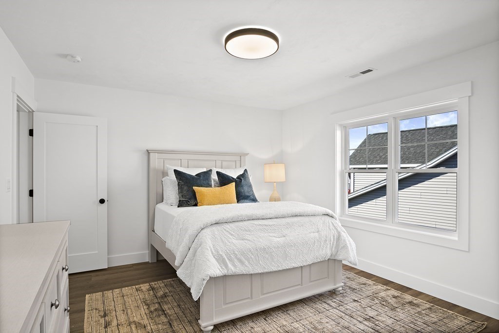 25 Salisbury Hill Boulevard, Unit 65 Worcester, MA 01609 - Photo 23 of 42 a bedroom with a bed and a window