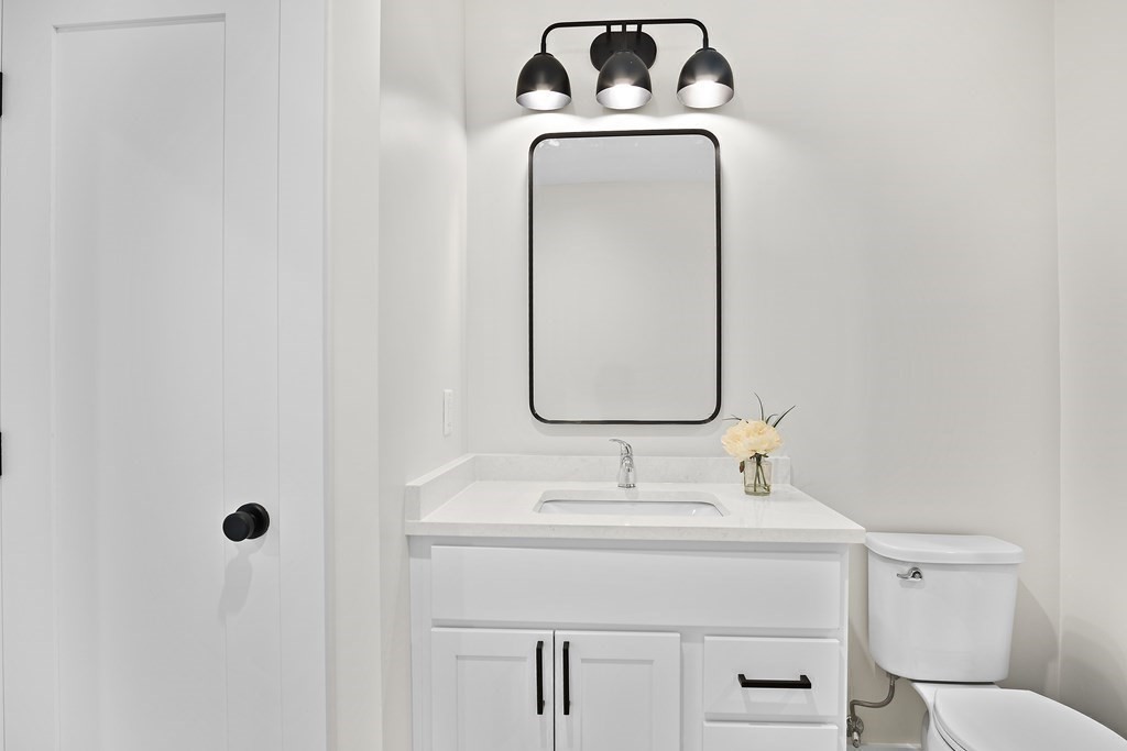 25 Salisbury Hill Boulevard, Unit 65 Worcester, MA 01609 - Photo 24 of 42 a bathroom with a sink mirror and toilet