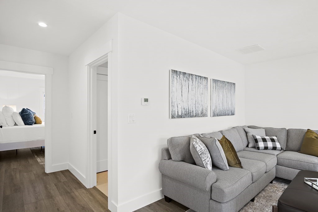 25 Salisbury Hill Boulevard, Unit 65 Worcester, MA 01609 - Photo 27 of 42 a living room with furniture and a wooden floor