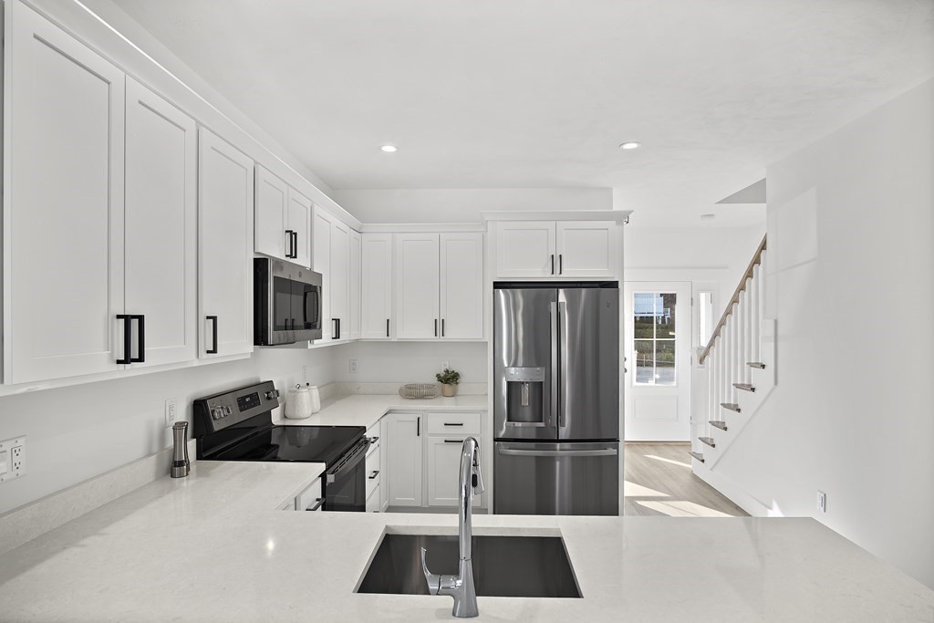 25 Salisbury Hill Boulevard, Unit 65 Worcester, MA 01609 - Photo 8 of 42 a kitchen with stainless steel appliances a refrigerator and a stove top oven
