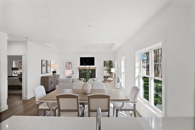 a dining room with furniture and wooden floor