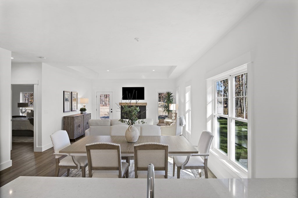25 Salisbury Hill Boulevard, Unit 65 Worcester, MA 01609 - Photo 9 of 42 a dining room with furniture and wooden floor