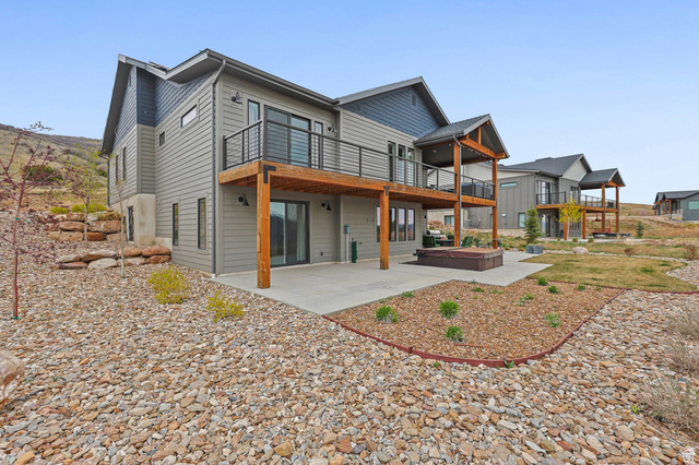4527 North Seven Bridges Road Eden, UT 84310 - Photo 44 of 65 Back of property with a patio area, a deck, and a hot tub