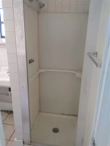 a bathroom with a glass shower door