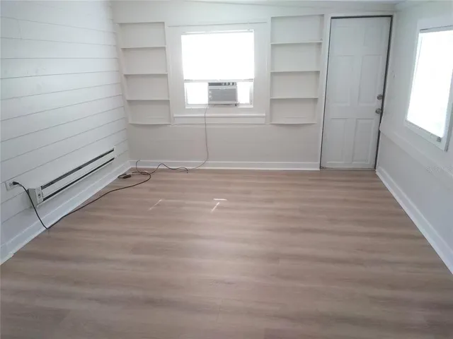 a view of a room with an empty space and window
