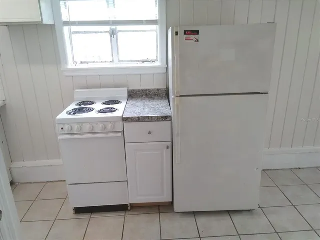 a stove top oven sitting inside of a kitchen